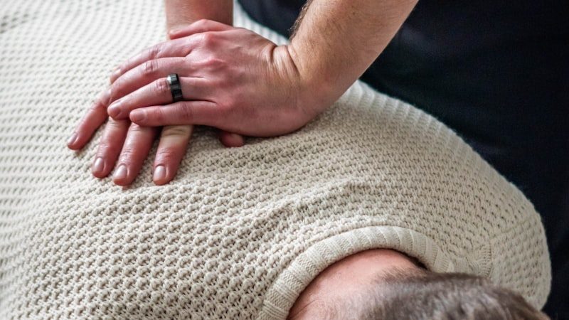 A chiropractor performing a hands-on spinal adjustment